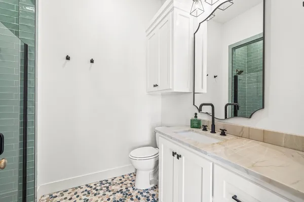 a large kitchen with stainless steel appliances granite countertop a sink a stove and a wooden floors