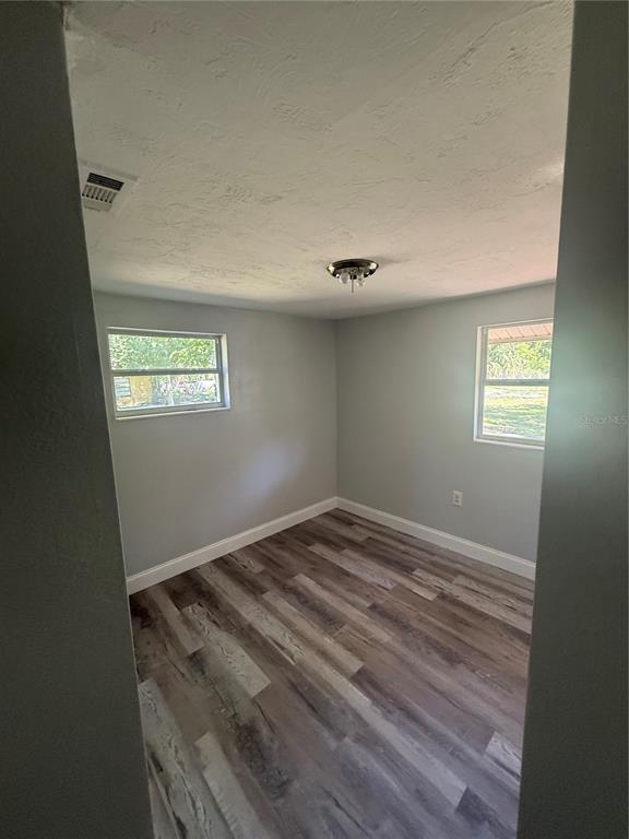 9029 Maiden Lane Aripeka, FL 34679 - Photo 6 of 11 a view of an empty room and window