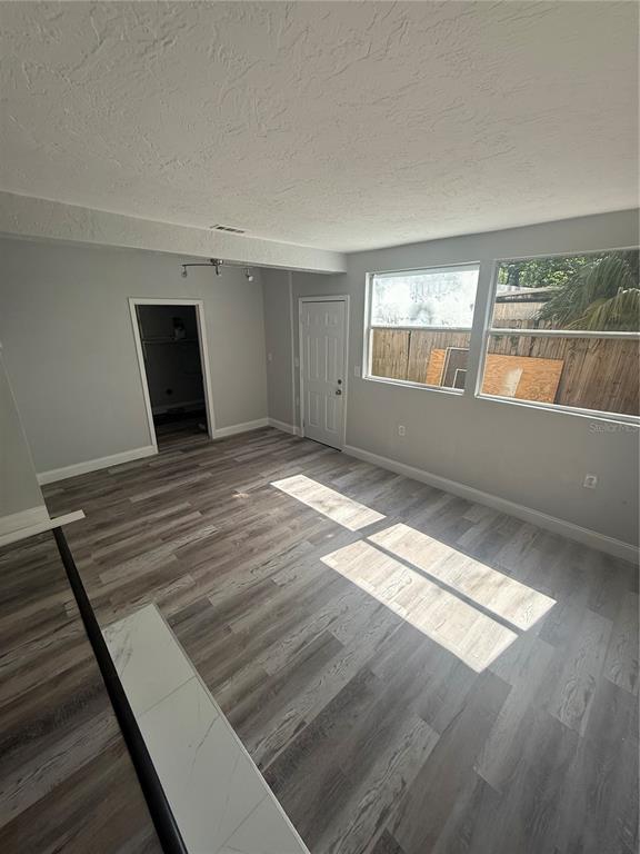 9029 Maiden Lane Aripeka, FL 34679 - Photo 7 of 11 a view of a room with wooden floor and window