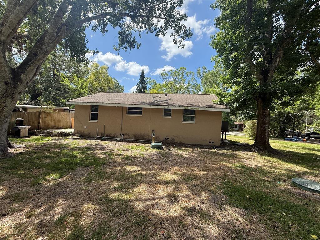 9029 Maiden Lane Aripeka, FL 34679 - Photo 10 of 11 a view of a house with a yard and large tree