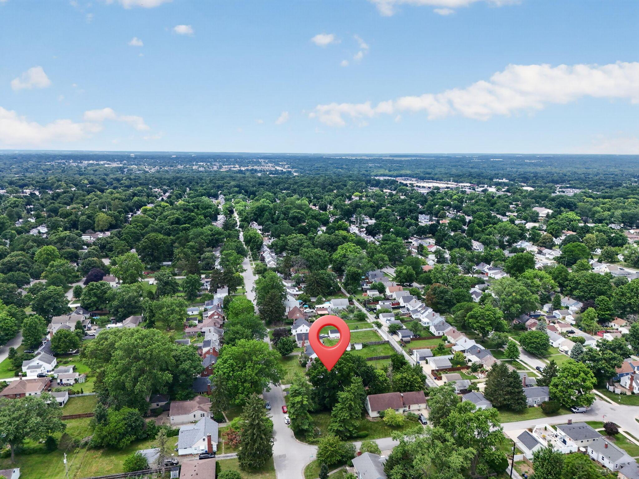 492 Wetmore Road Columbus, OH 43214 - Photo 51 of 55 Aerial perspective of a tree-lined residential area under a clear sky