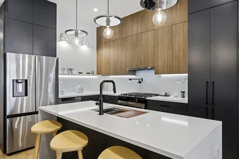 a kitchen with a table chairs sink and refrigerator