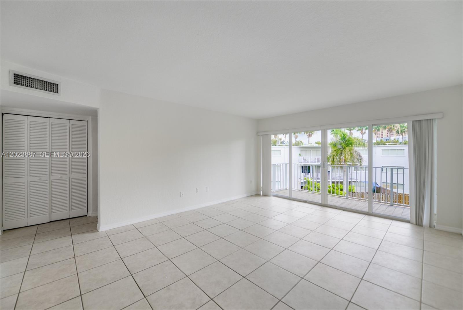 7737 Southwest 88th Street, Unit C312 Miami, FL 33156 - Photo 4 of 32 a view of an empty room with a window