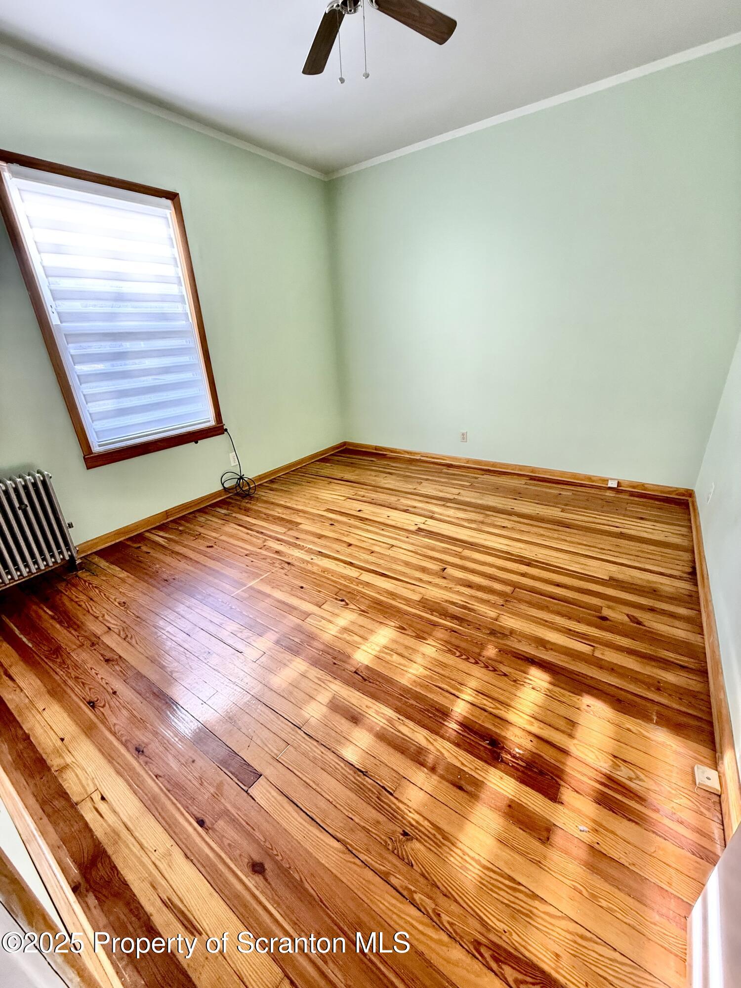 1012 North Webster Avenue, Unit FIRST Scranton, PA 18510 - Photo 13 of 23 a view of a room with wooden floor and ceiling fan