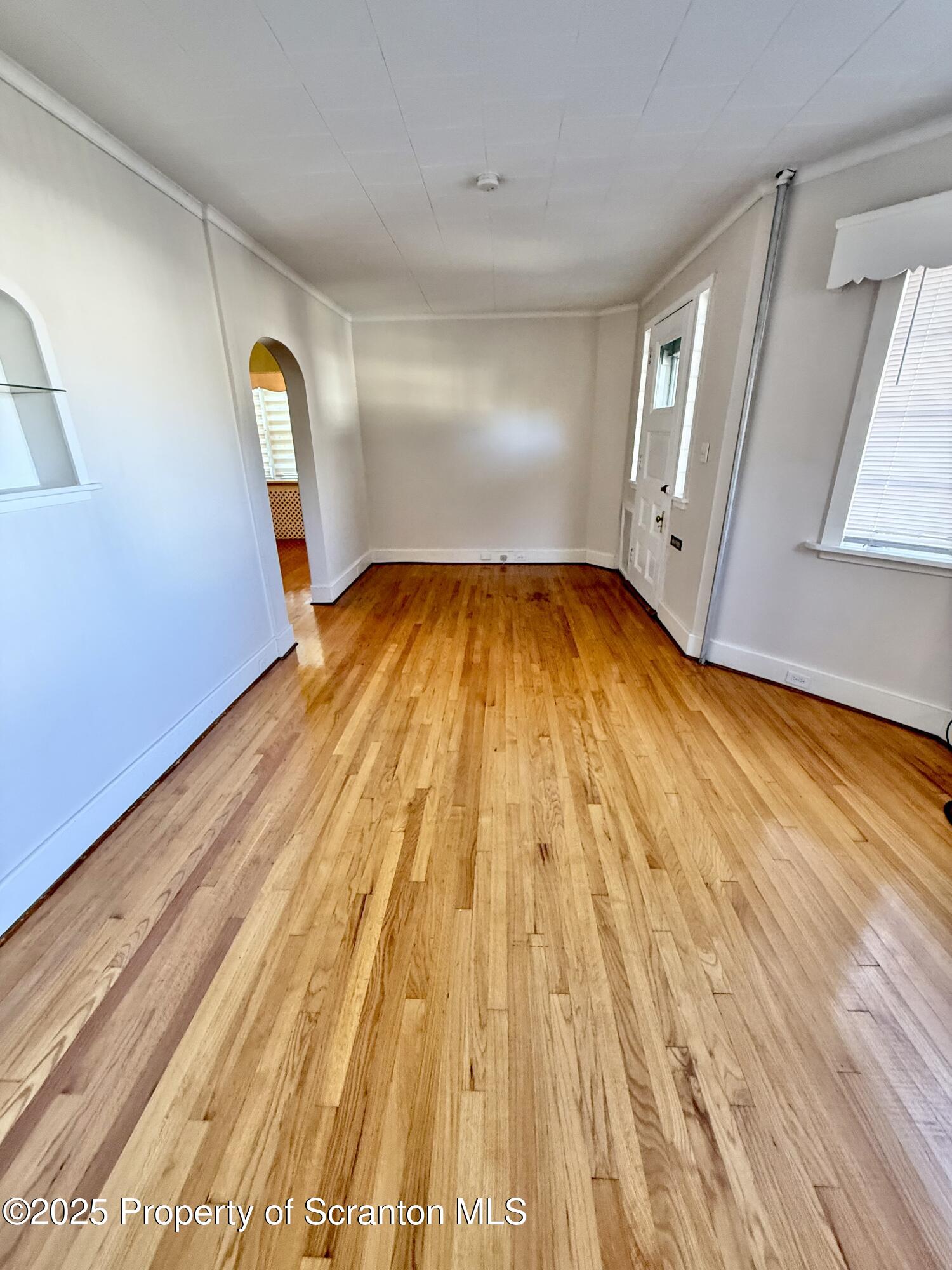 1012 North Webster Avenue, Unit FIRST Scranton, PA 18510 - Photo 19 of 23 a view of empty room with wooden floor and fan