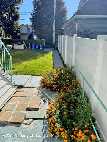 a view of swimming pool with a garden and plants