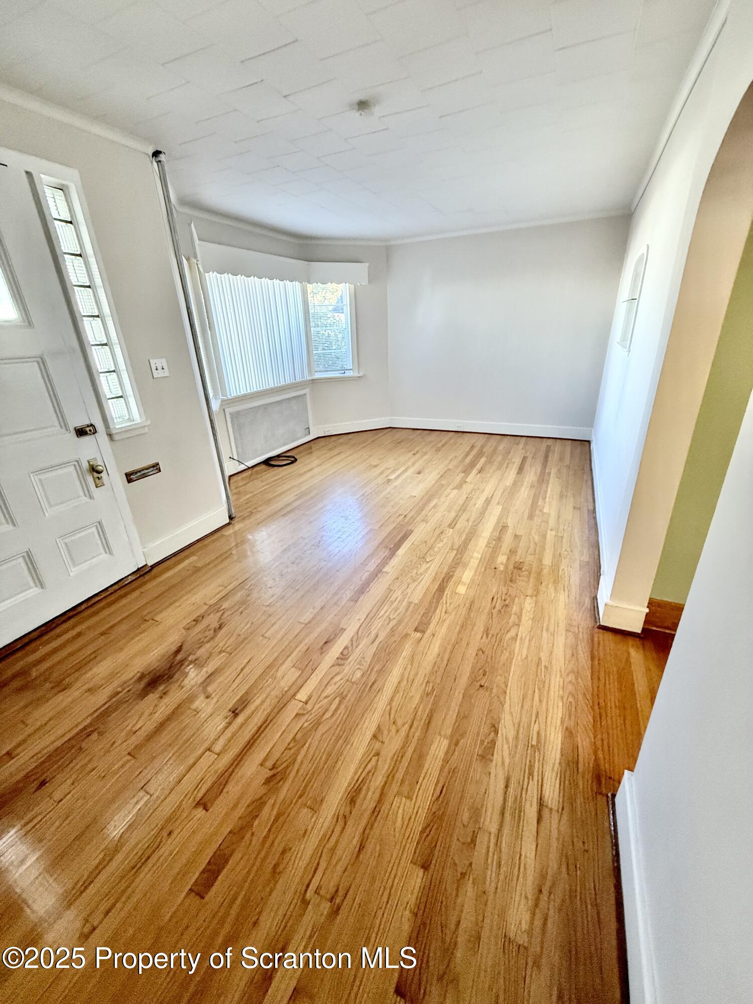 1012 North Webster Avenue, Unit FIRST Scranton, PA 18510 - Photo 3 of 23 wooden floor in an empty room with a window