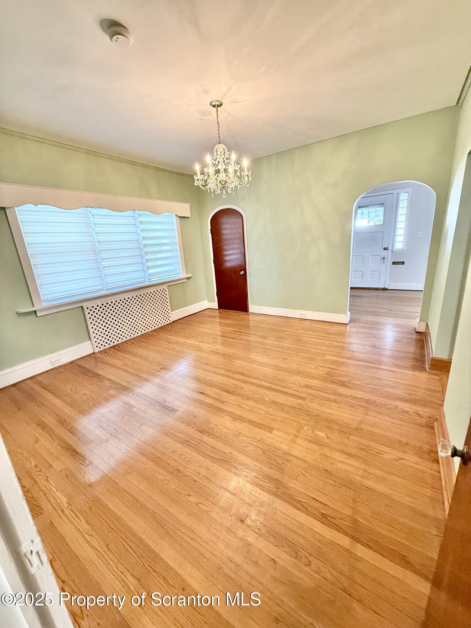 1012 North Webster Avenue, Unit FIRST Scranton, PA 18510 - Photo 4 of 23 a view of a room with wooden floor and a potted plant