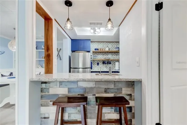a kitchen with stainless steel appliances granite countertop a sink and cabinets