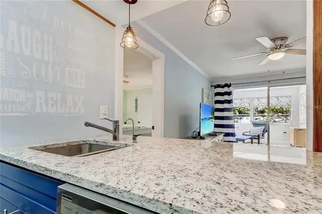 a kitchen with stainless steel appliances granite countertop a sink and a stove