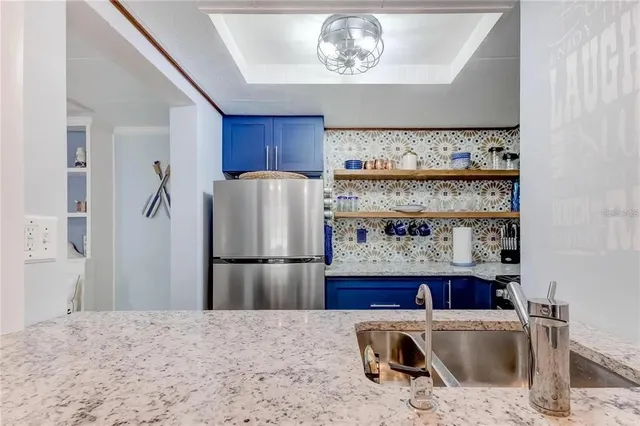 a kitchen with a refrigerator and a sink