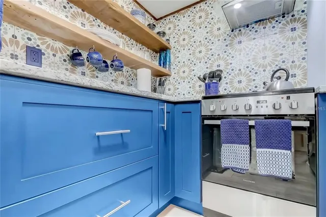 a kitchen with a refrigerator and countertop cabinets