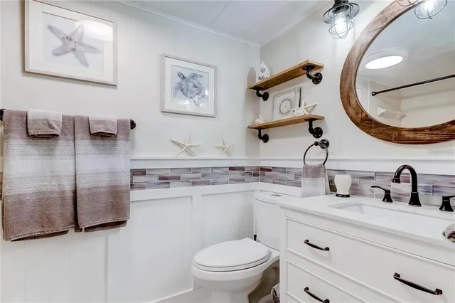 a bathroom with a sink a mirror and vanity