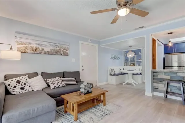 a living room with furniture and view of kitchen