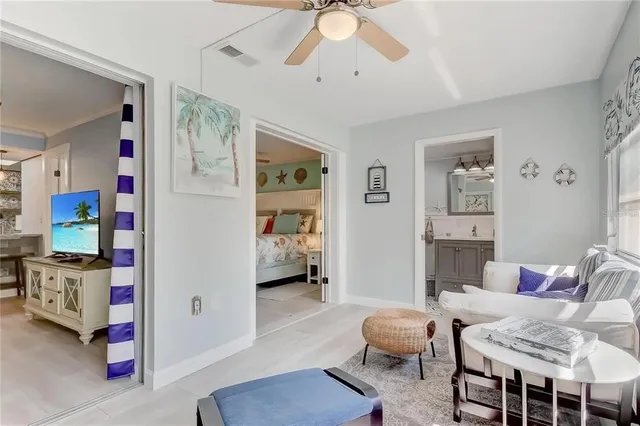 a living room with furniture and baby crib