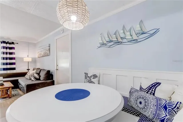 a living room with furniture and chandelier