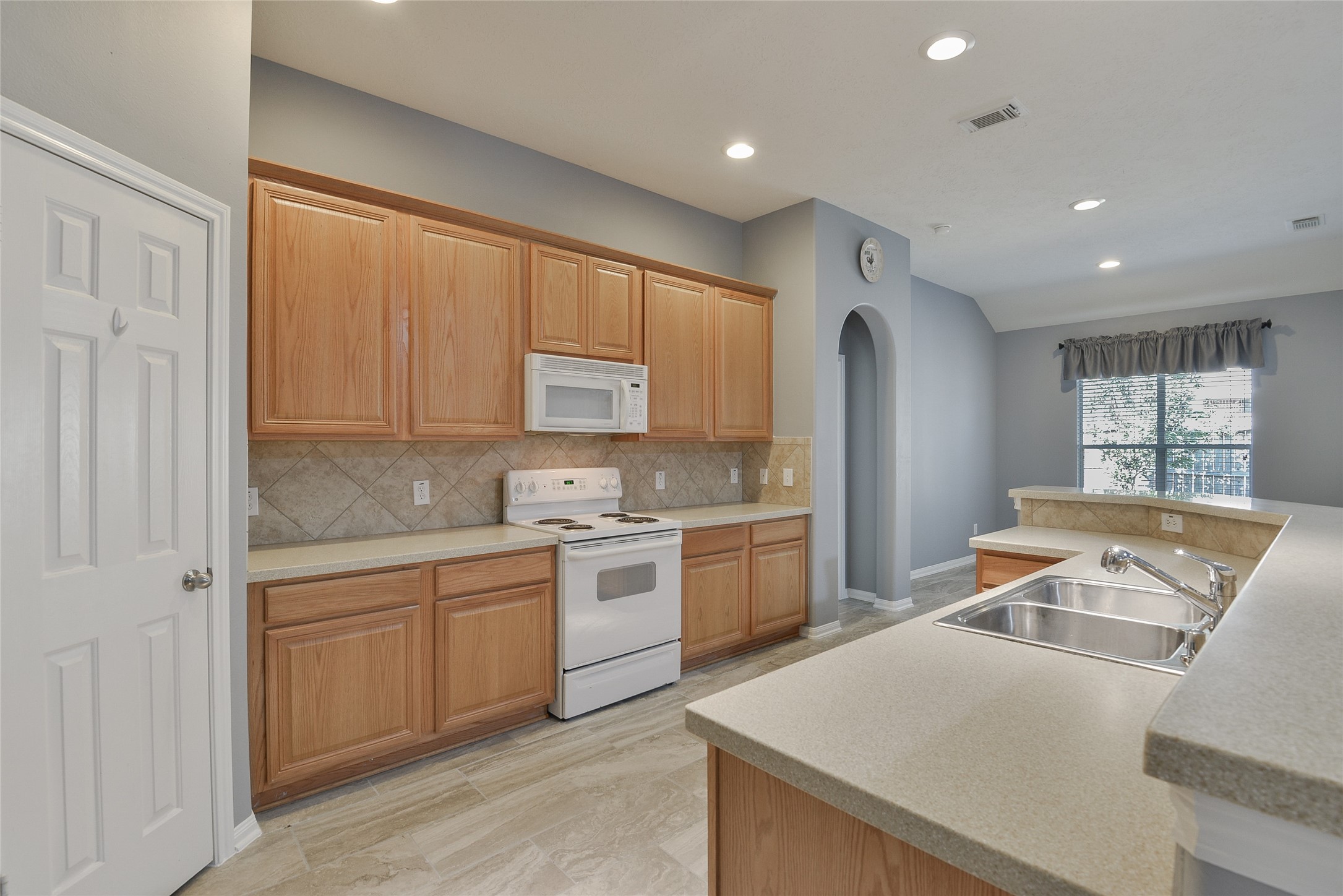 18411 Atasca Wds Trace Humble, TX 77346 - Photo 14 of 39 a room with a stove a sink dishwasher and a refrigerator