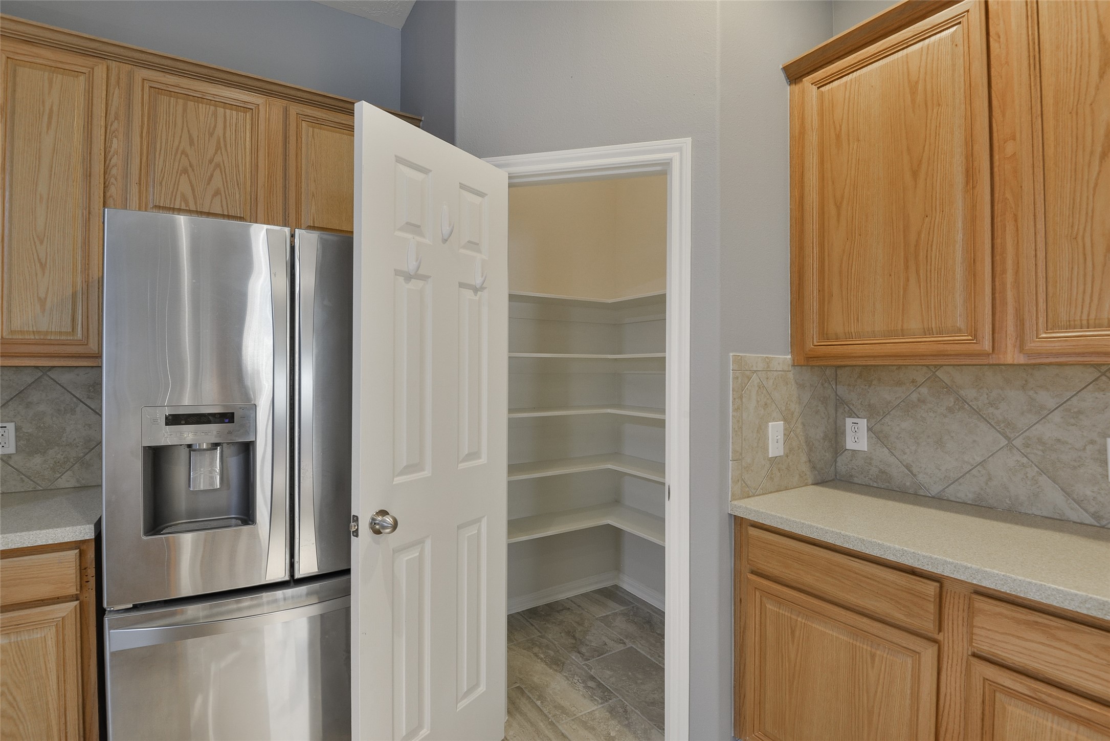 18411 Atasca Wds Trace Humble, TX 77346 - Photo 15 of 39 a kitchen with stainless steel appliances a refrigerator and cabinets