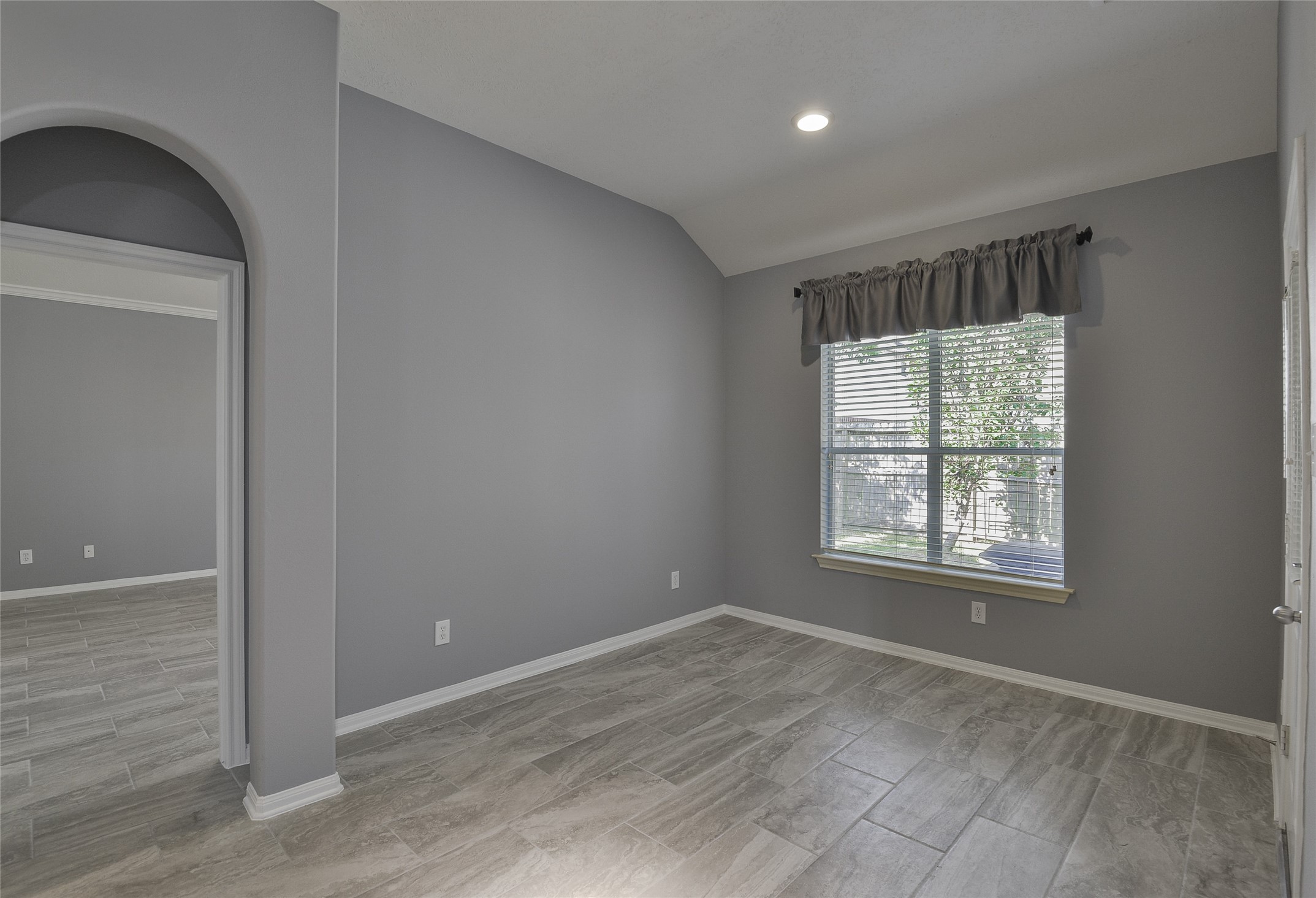 18411 Atasca Wds Trace Humble, TX 77346 - Photo 18 of 39 an empty room with wooden floor and windows