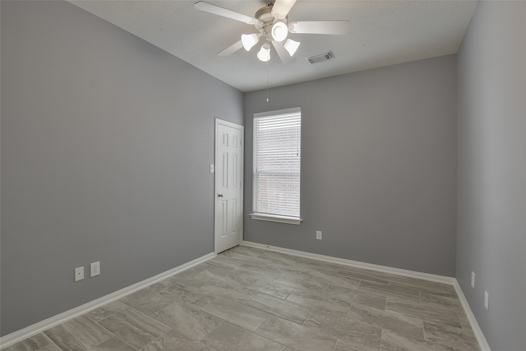 18411 Atasca Wds Trace Humble, TX 77346 - Photo 29 of 39 an empty room with a chandelier fan and windows
