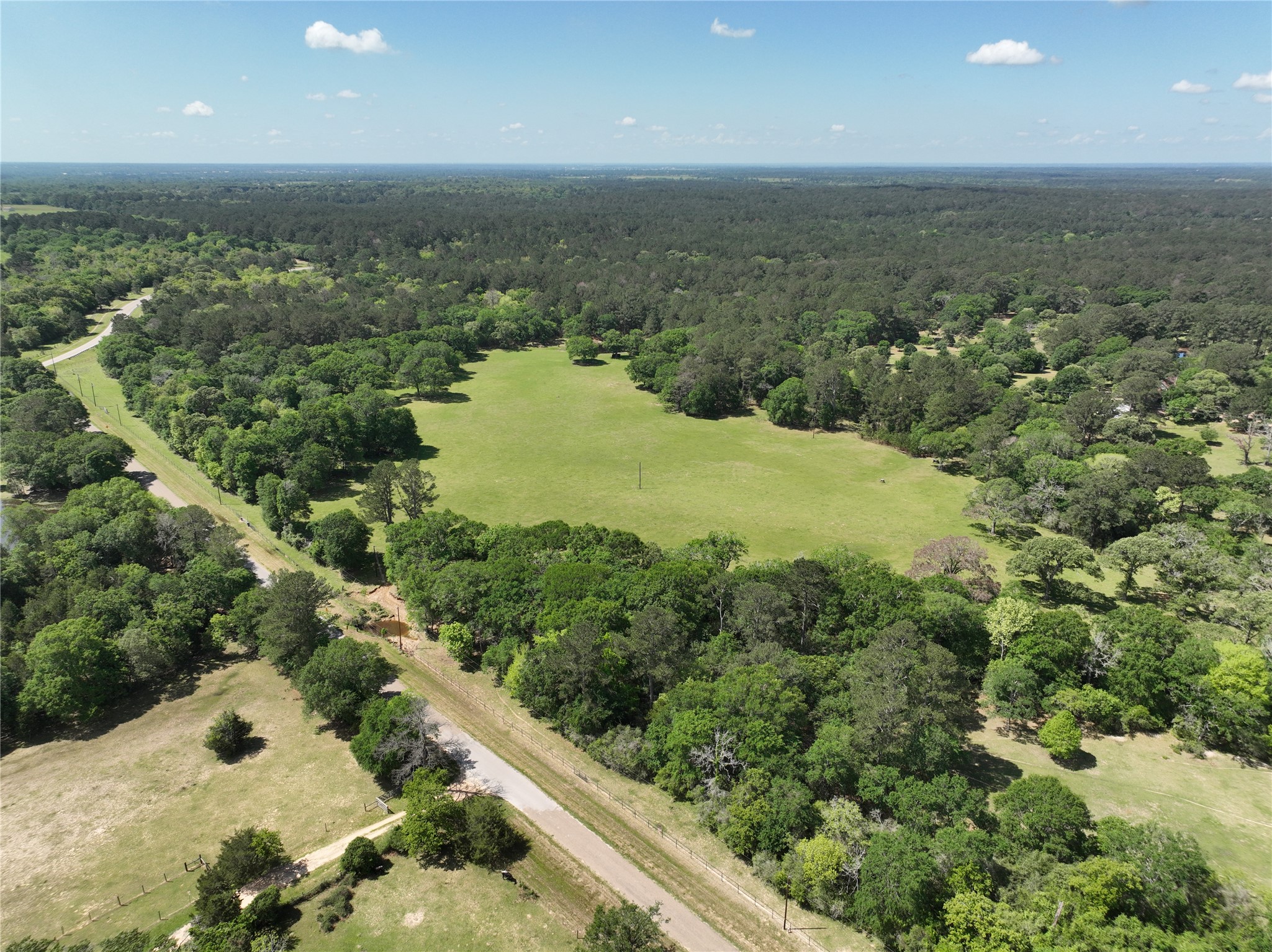 32023 Courtney Road Navasota, TX 77868 - Photo 11 of 37 an aerial view of mountain with residential house and green space