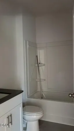 a white toilet sitting next to a bath tub