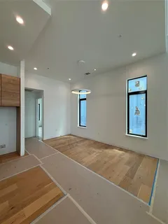 a view of kitchen with kitchen island stainless steel appliances a sink and cabinets