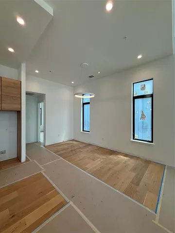 a view of kitchen with kitchen island stainless steel appliances a sink and cabinets