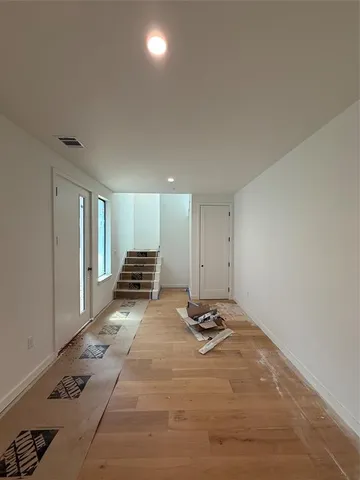 a large kitchen with stainless steel appliances a large counter top