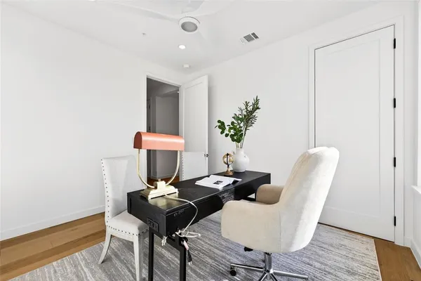 a view of a room with furniture and wooden floor