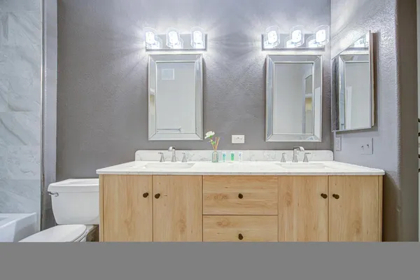 a bathroom with a toilet sink and mirror
