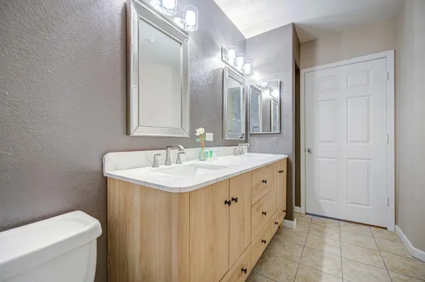 a bathroom with a double vanity sink and a mirror