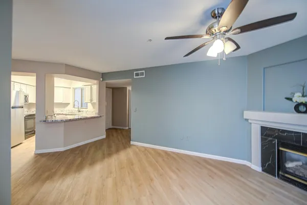 an empty room with windows and fireplace