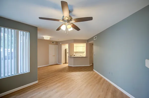 wooden floor in an empty room with a window