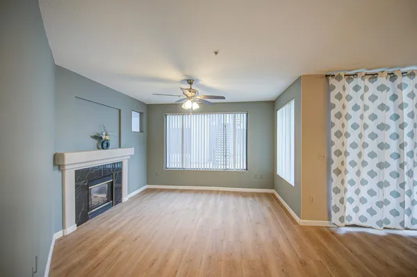 a view of an empty room with a fireplace and a window