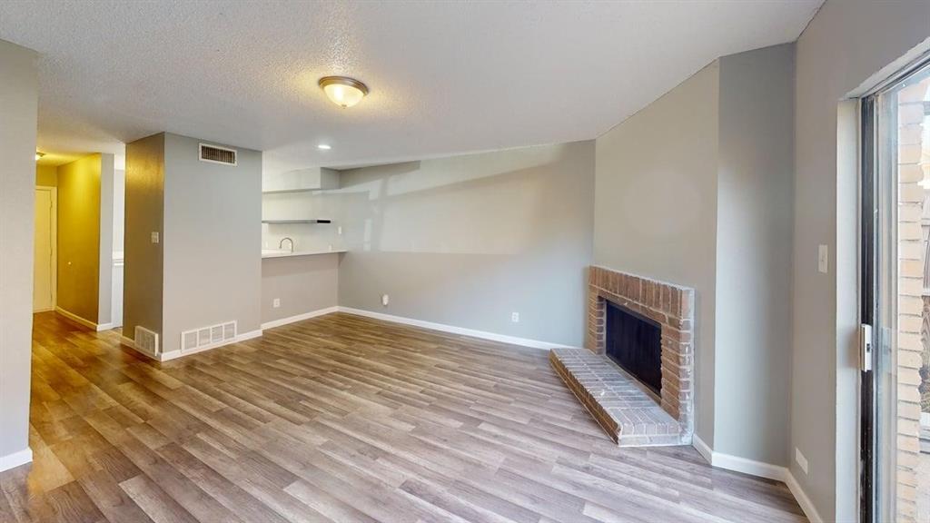 8108 Foxfire Lane, Unit B White Settlement, TX 76108 - Photo 9 of 12 a view of empty room with wooden floor and fan