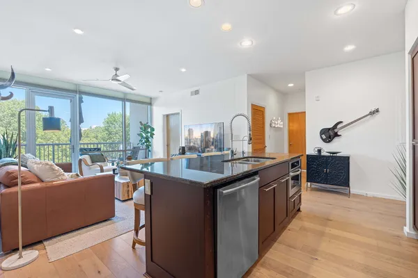 a kitchen with granite countertop a stove and a sink