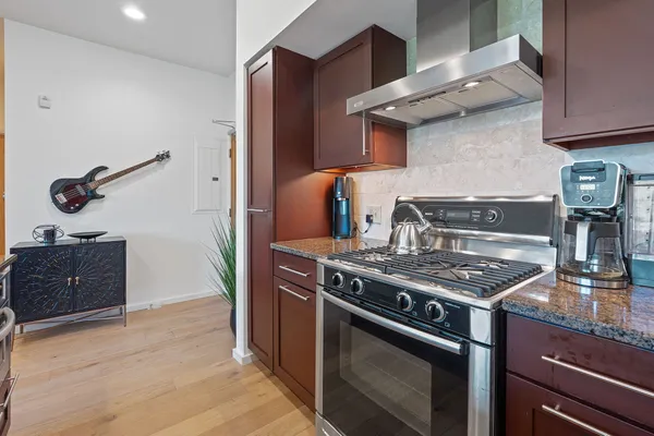 a stove top oven sitting inside of a kitchen