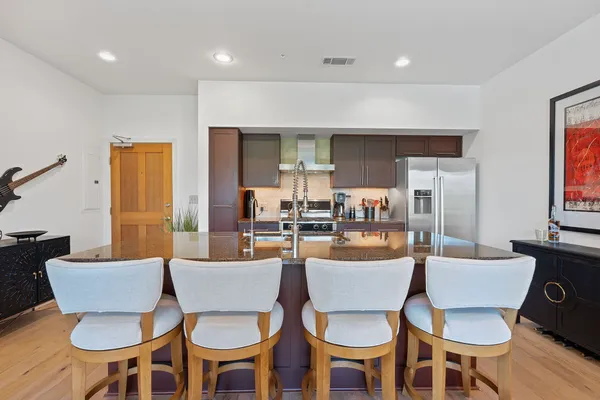 a dining room with furniture a window and kitchen view