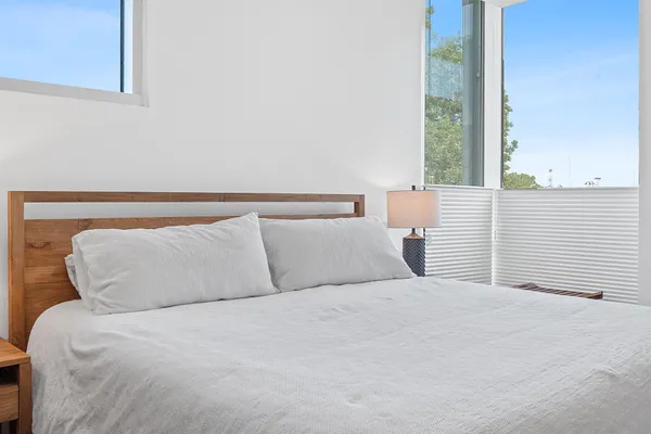 a bedroom with a large bed and a large window