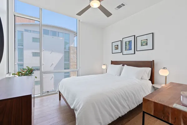 a bedroom with a bed and a potted plant
