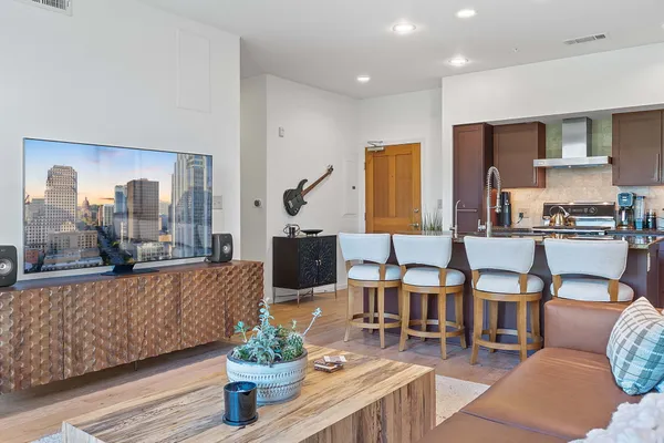 a living room with fireplace furniture and a potted plant