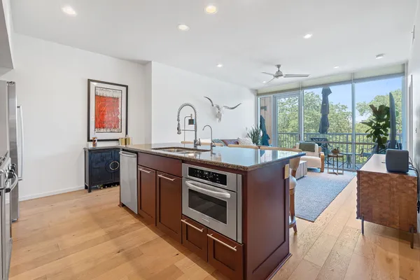a kitchen with stainless steel appliances granite countertop a stove and a sink