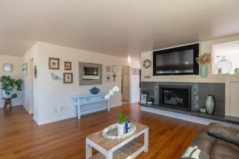 a living room with furniture a fireplace and a flat screen tv