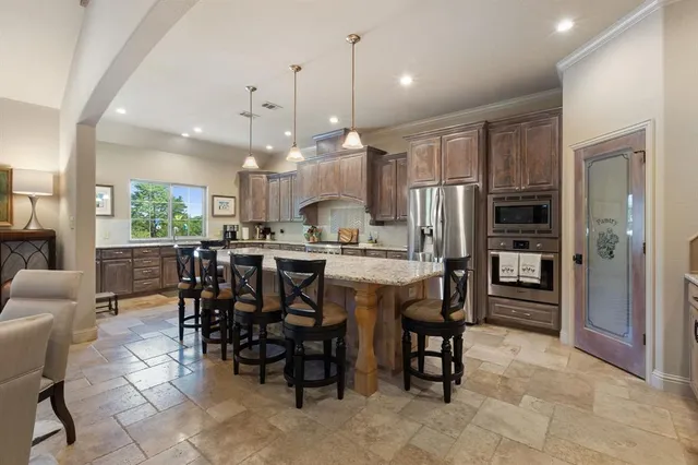 a large kitchen with a table and chairs
