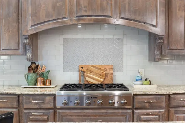a stove top oven sitting inside of a kitchen