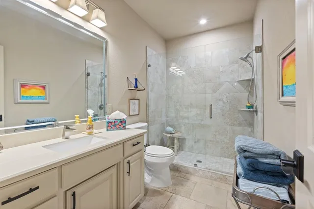 a view of bathroom with a sink mirror toilet and next to a window