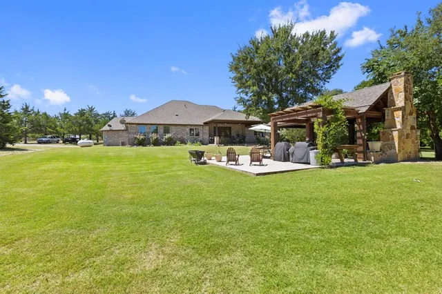 a front view of a house with patio swimming pool and outdoor seating