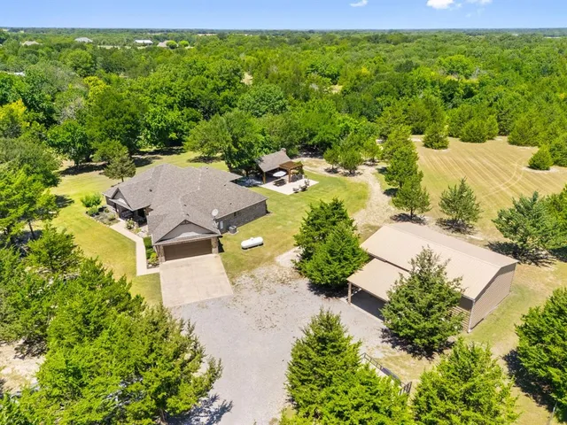 an aerial view of a house with a yard