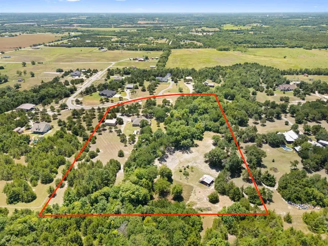 an aerial view of residential houses with outdoor space and river